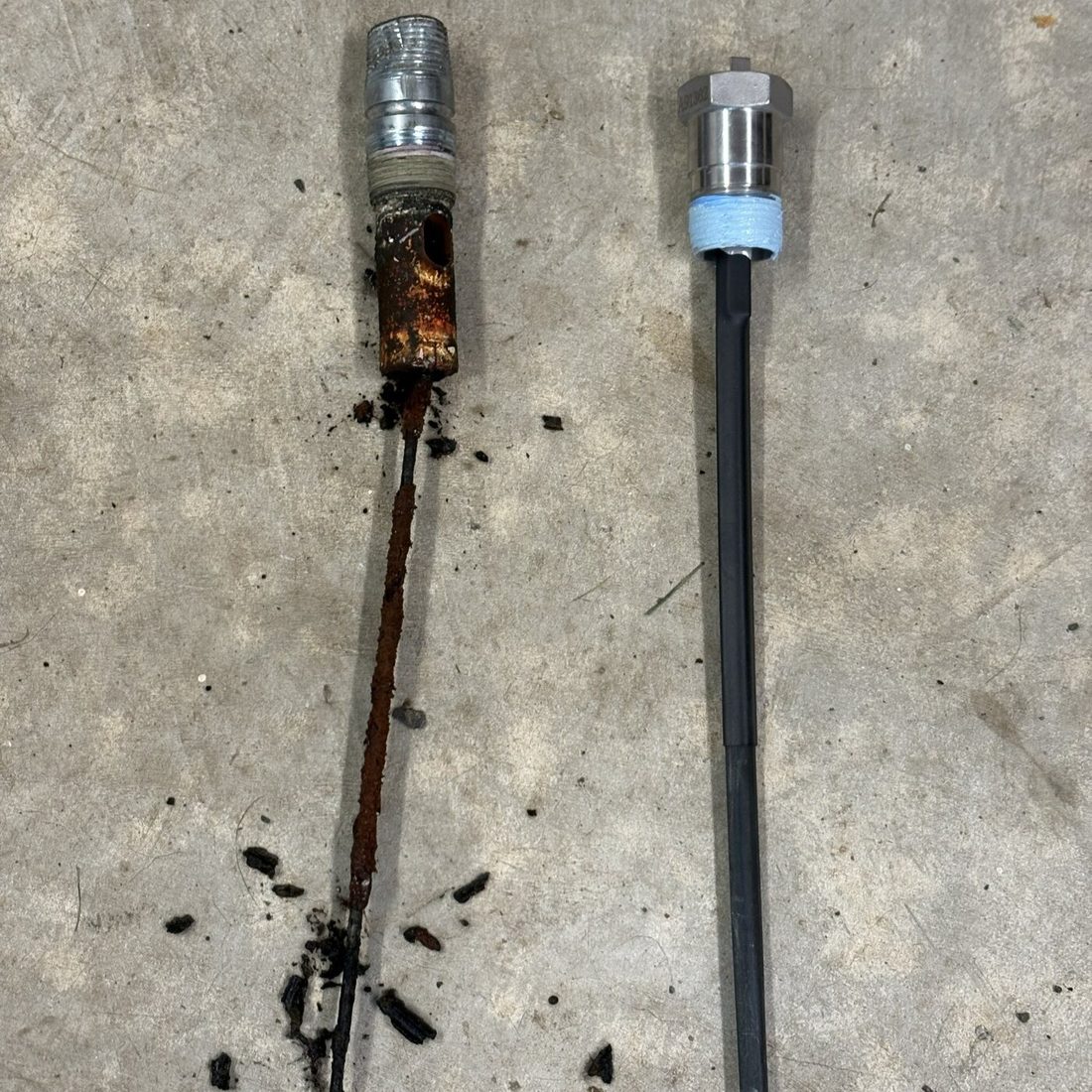 Powered anode rod next to a corroded water heater anode rod